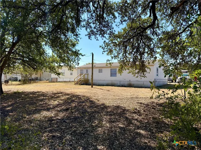 a backyard of a house with large trees