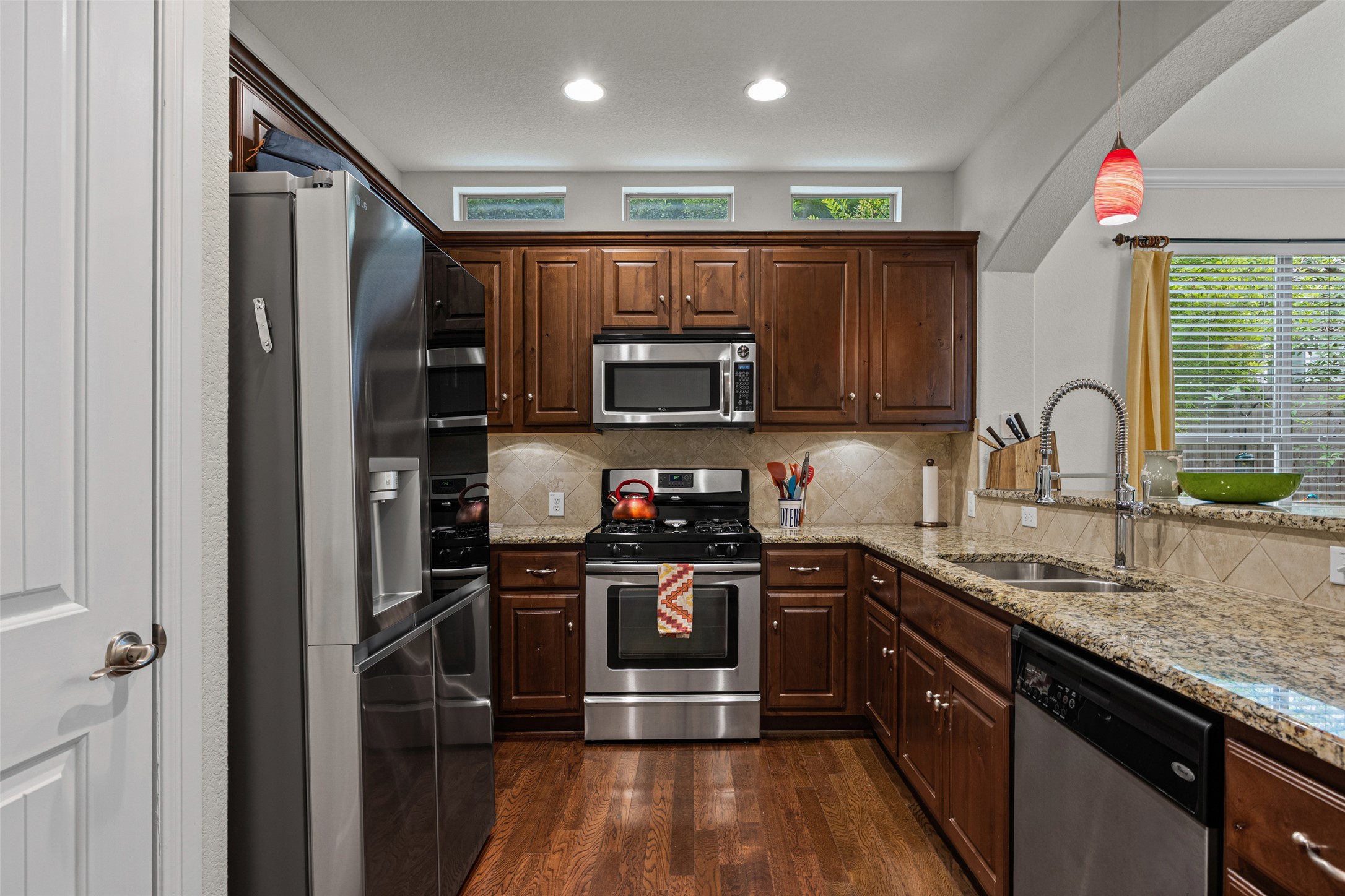 6708 Menchaca Road, Unit 10 Austin, TX 78745 - Photo 7 of 30 Culinary adventures await in this kitchen, featuring rich cabinetry and a sun-drenched window over the sink.