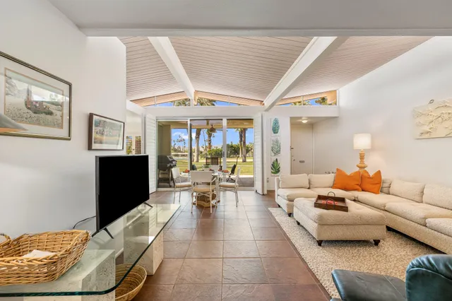 a white kitchen with a table and chairs