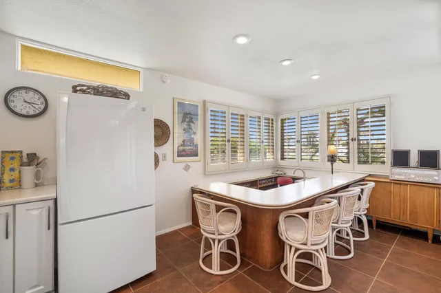 a bedroom with a bed and a flat tv screen on wall