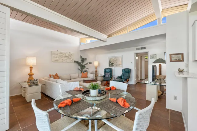 a dining room with furniture and wooden floor