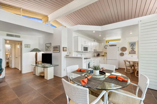 a bathroom with a granite countertop sink a mirror and a shower
