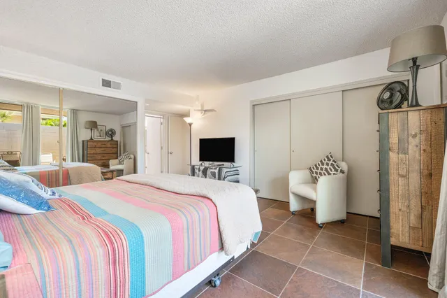 a bathroom with a granite countertop sink mirror vanity and toilet