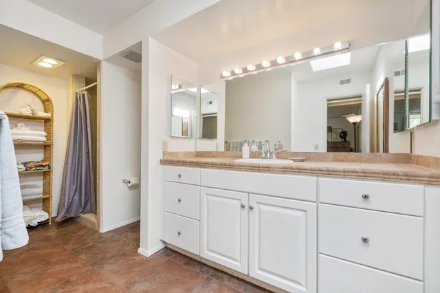 a living room with patio furniture and a floor to ceiling window