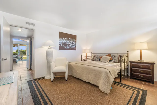 a view of a chairs and table in patio with a lake view