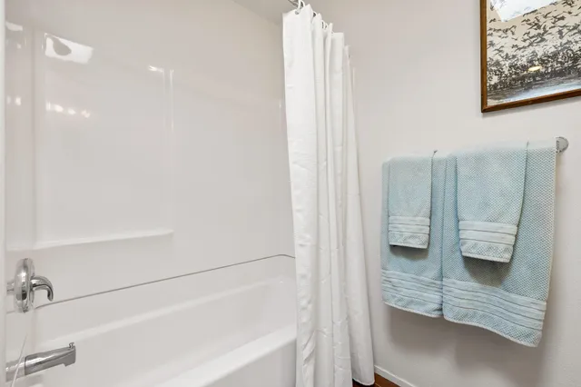 a view of a city street with a car parked on the roadside