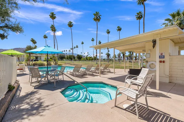 swimming pool view with a outdoor seating space