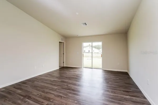 a view of kitchen with refrigerator microwave and stove