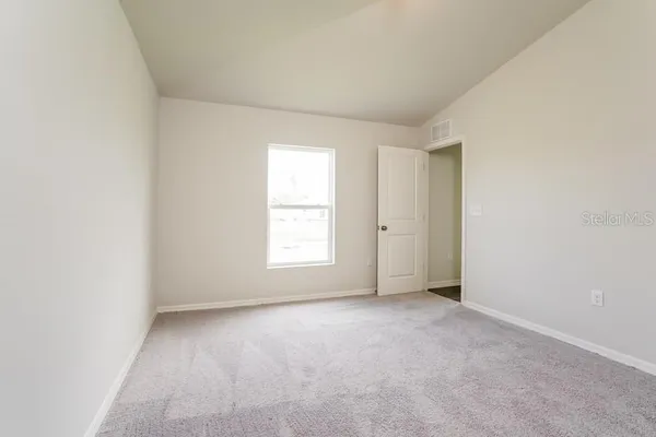 an empty room with window and windows