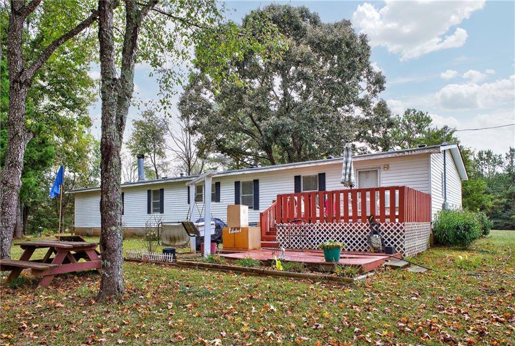 1090 South Hampton Road Hampton, GA 30228 - Photo 11 of 13 a view of a house with a patio and a yard