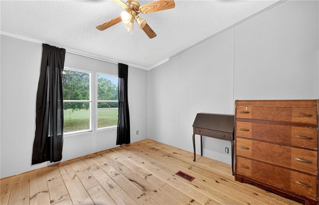 1090 South Hampton Road Hampton, GA 30228 - Photo 7 of 13 a bedroom with a bed and a window