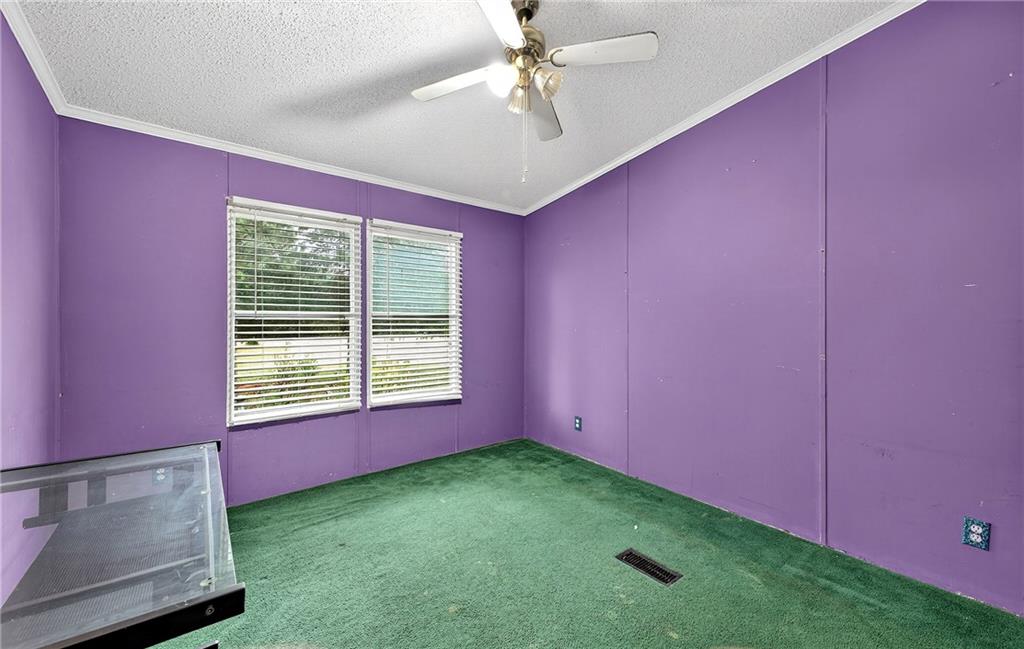 1090 South Hampton Road Hampton, GA 30228 - Photo 8 of 13 a view of an empty room with a window and a ceiling fan
