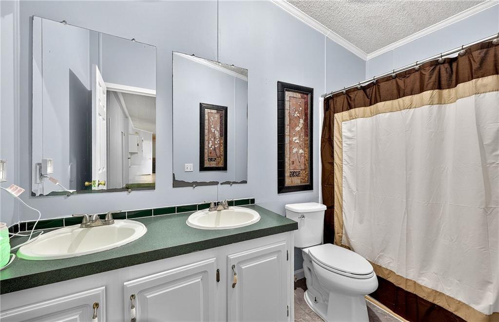 1090 South Hampton Road Hampton, GA 30228 - Photo 10 of 13 a bathroom with a granite countertop sink and a mirror a toilet