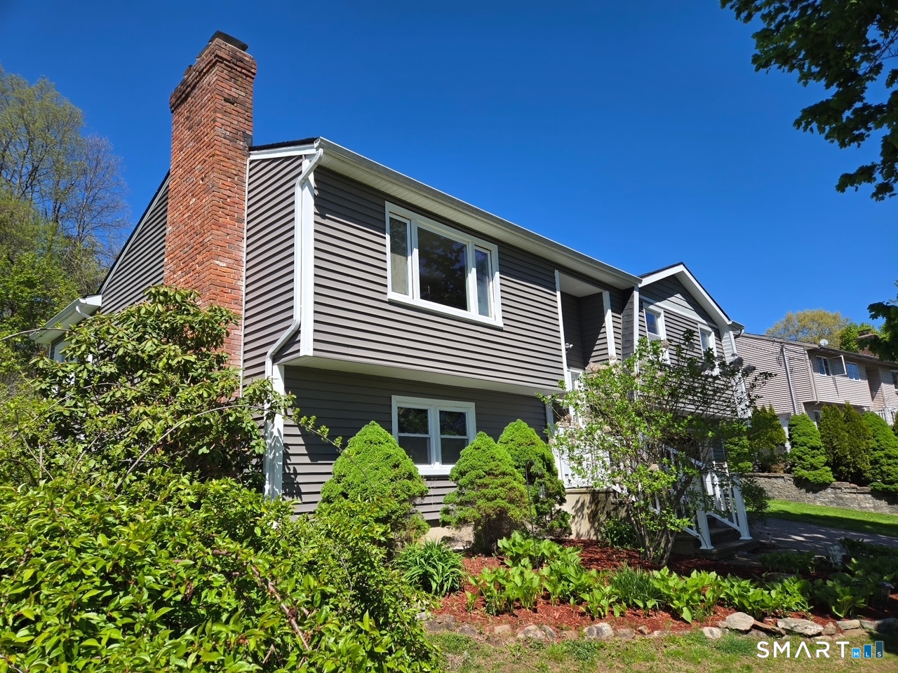 1004 Hickory Hill Road Thomaston, CT 06787 - Photo 3 of 23 a front view of a house with a yard