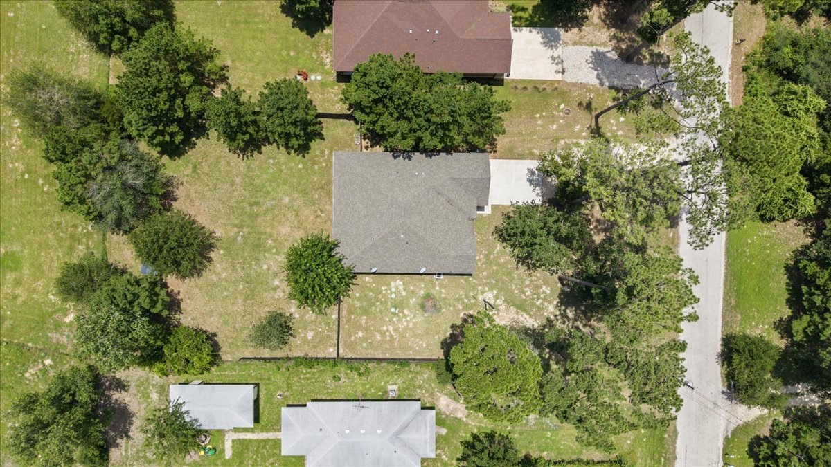145 Cardinal Loop Paige, TX 78659 - Photo 38 of 40 An aerial perspective reveals the property's generous land surrounded by natural green space.