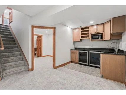 a view of kitchen with stainless steel appliances granite countertop a stove and a refrigerator