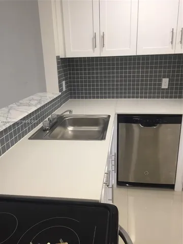 a kitchen with a sink and cabinets