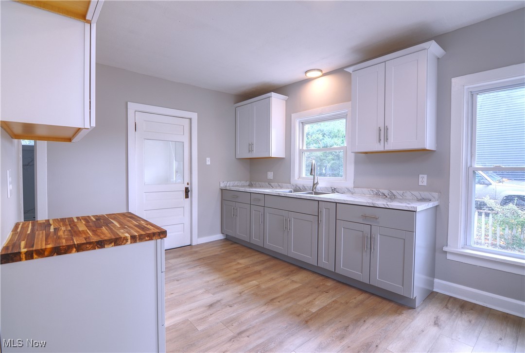 12341 Portage Street Rittman, OH 44270 - Photo 10 of 23 Kitchen with gray cabinets, white cabinets, light hardwood / wood-style flooring, and wood counters
