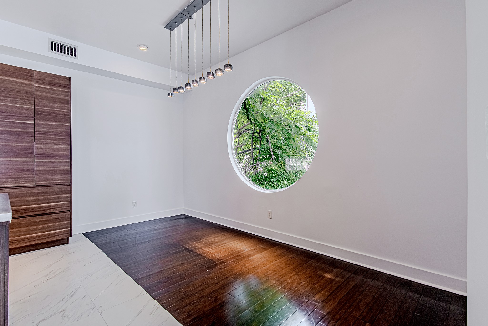 2025 Colquitt Street, Unit E Houston, TX 77098 - Photo 11 of 29 Unique architectural feature with circular window, adding character and natural light.