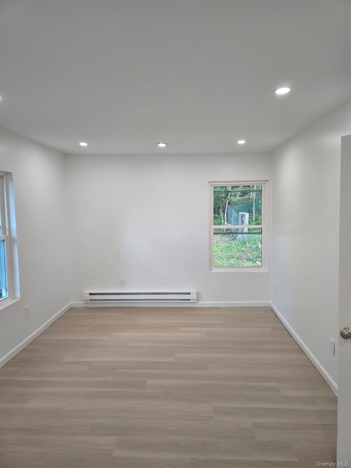 2016 Old Rte 17 Roscoe, NY 12776 - Photo 16 of 26 an empty room with wooden floor and windows