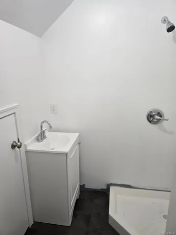 a kitchen with stainless steel appliances a stove and white cabinets