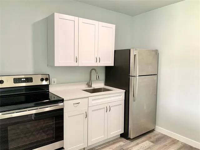 a kitchen with a stove microwave and refrigerator