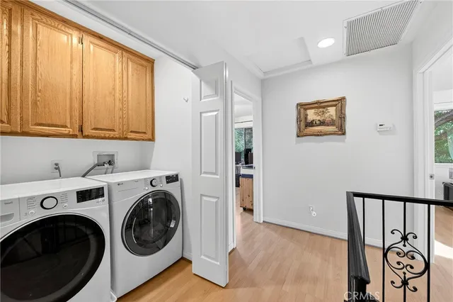 a view of a hallway with washer and dryer