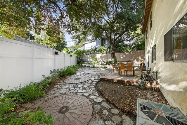 a view of a backyard with sitting area
