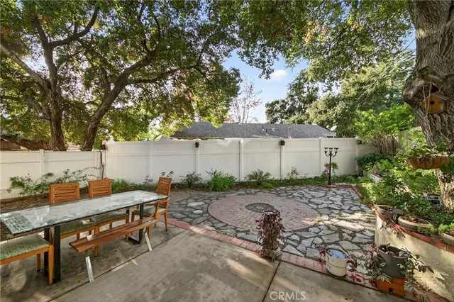 a backyard of a house with table and chairs