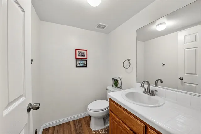 a bathroom with a sink toilet and a mirror