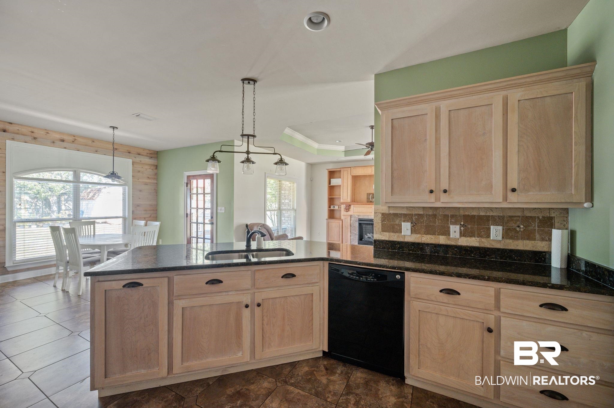 3879 Symphony Way West Semmes, AL 36575 - Photo 13 of 34 Kitchen with black dishwasher, sink, dark tile patterned floors, ceiling fan with notable chandelier, and tasteful backsplash