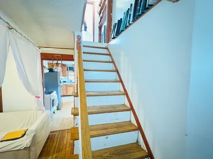 a view of entryway and hall with wooden floor