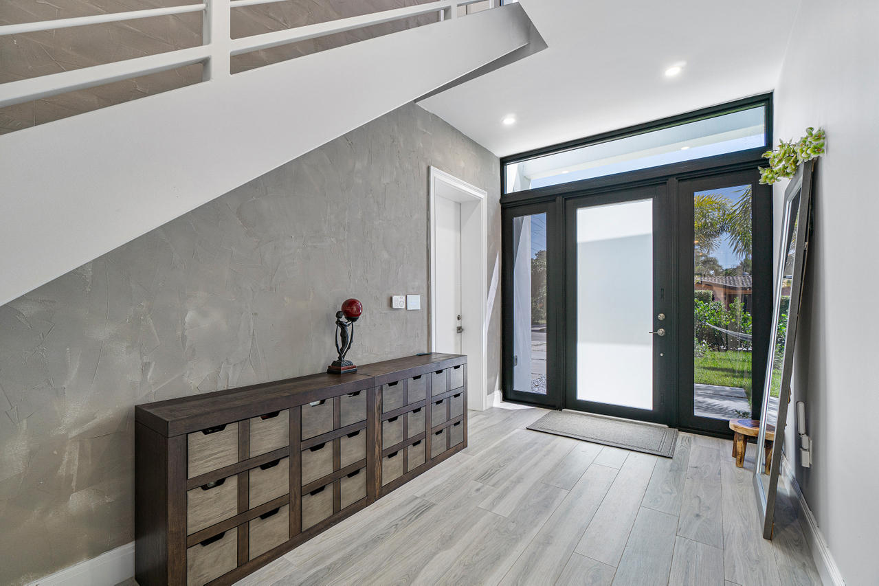 709 Northwest 6th Drive Boca Raton, FL 33486 - Photo 2 of 20 a view of a hallway with wooden floor and staircase