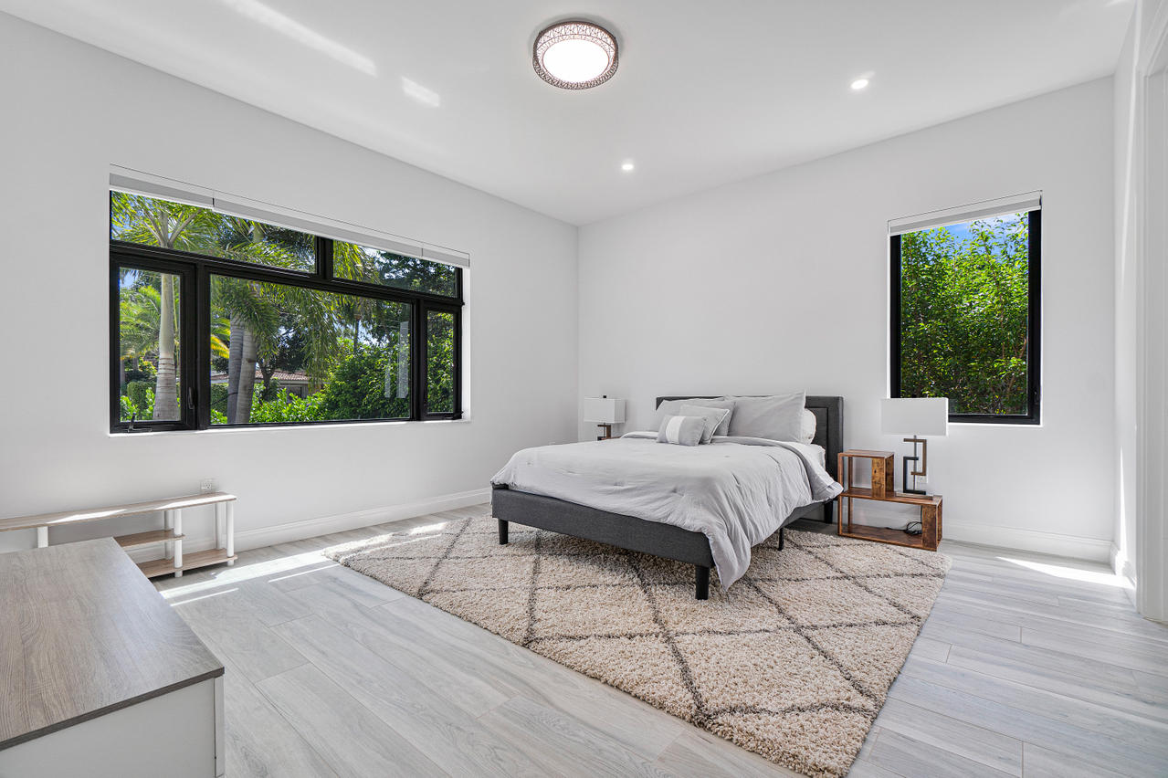 709 Northwest 6th Drive Boca Raton, FL 33486 - Photo 15 of 20 a spacious bedroom with a large bed and a window