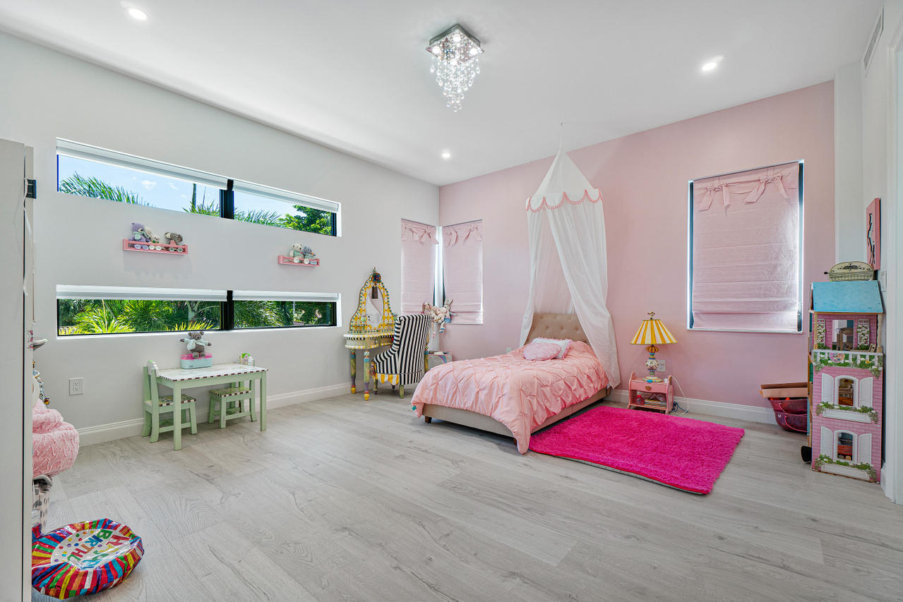 709 Northwest 6th Drive Boca Raton, FL 33486 - Photo 17 of 20 a bedroom with furniture and a wooden floor