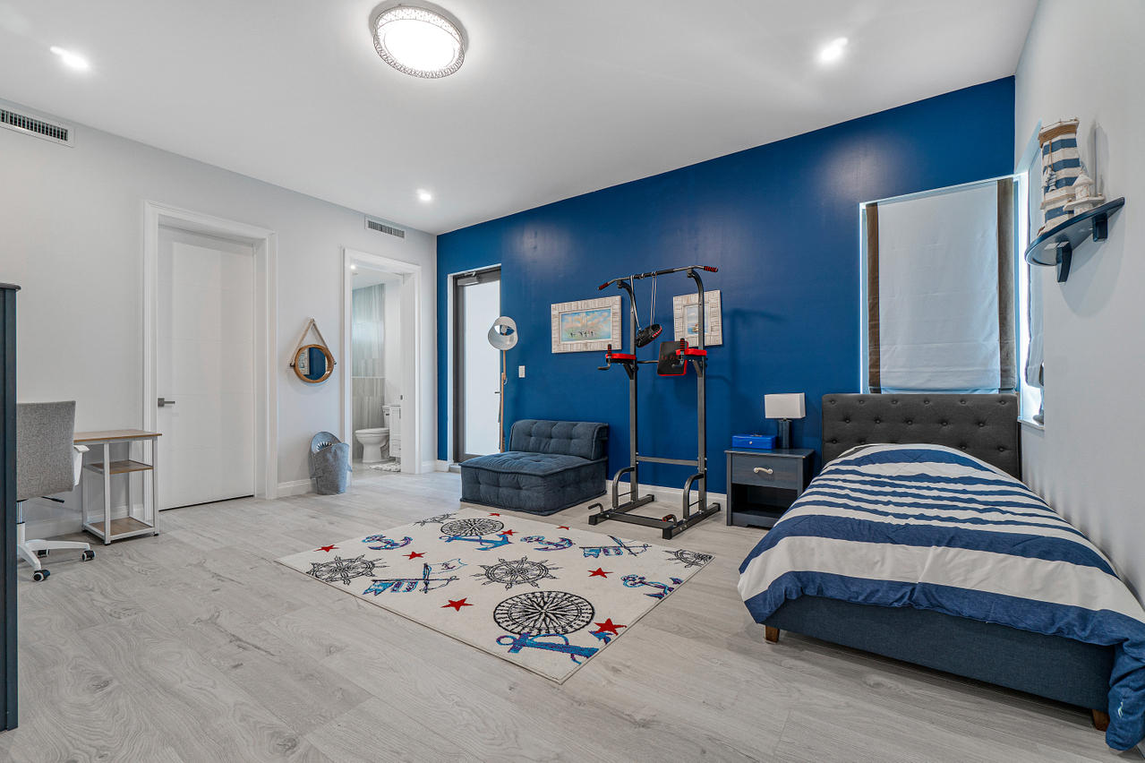 709 Northwest 6th Drive Boca Raton, FL 33486 - Photo 19 of 20 a bedroom with bed and window