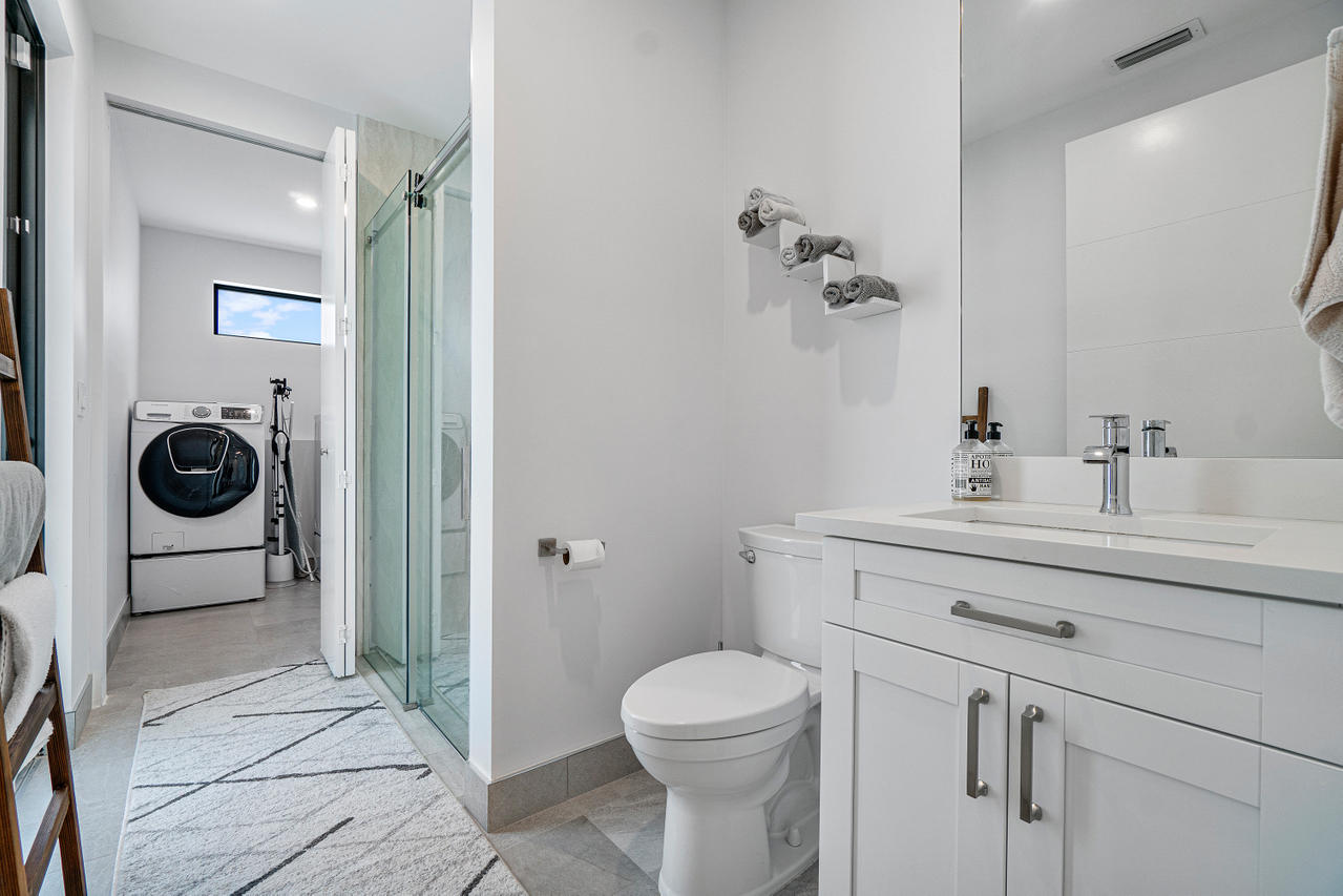 709 Northwest 6th Drive Boca Raton, FL 33486 - Photo 9 of 20 a bathroom with a sink a toilet and a mirror