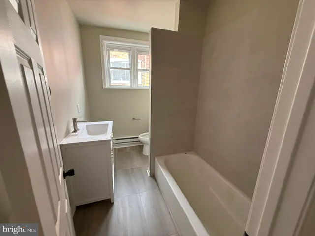 a bathroom with a bathtub and toilet