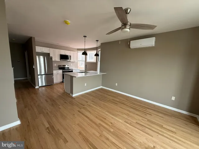 a kitchen with stainless steel appliances a refrigerator and a stove top oven