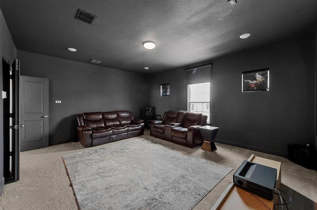 10969 Coastal Violet Road Frisco, TX 75035 - Photo 26 of 30 Living room with carpet floors, a textured ceiling, and recessed lighting