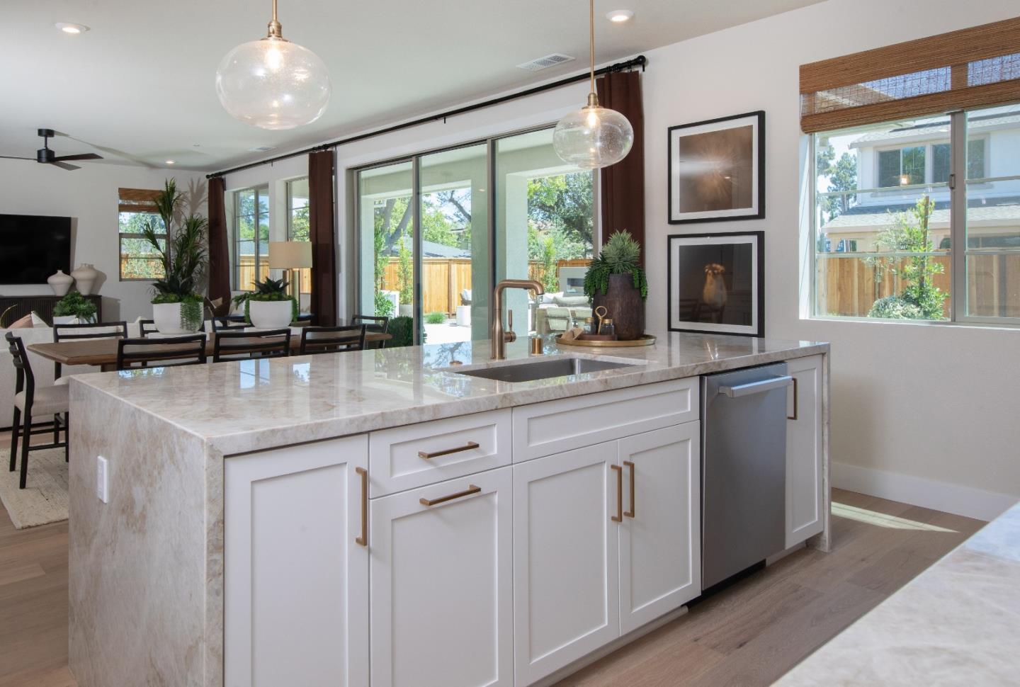 7351 Princevalle Street, Unit HOMESITE 18 Gilroy, CA 95020 - Photo 5 of 12 a kitchen with stainless steel appliances granite countertop a stove a sink and a granite counter tops with white cabinets next to a window