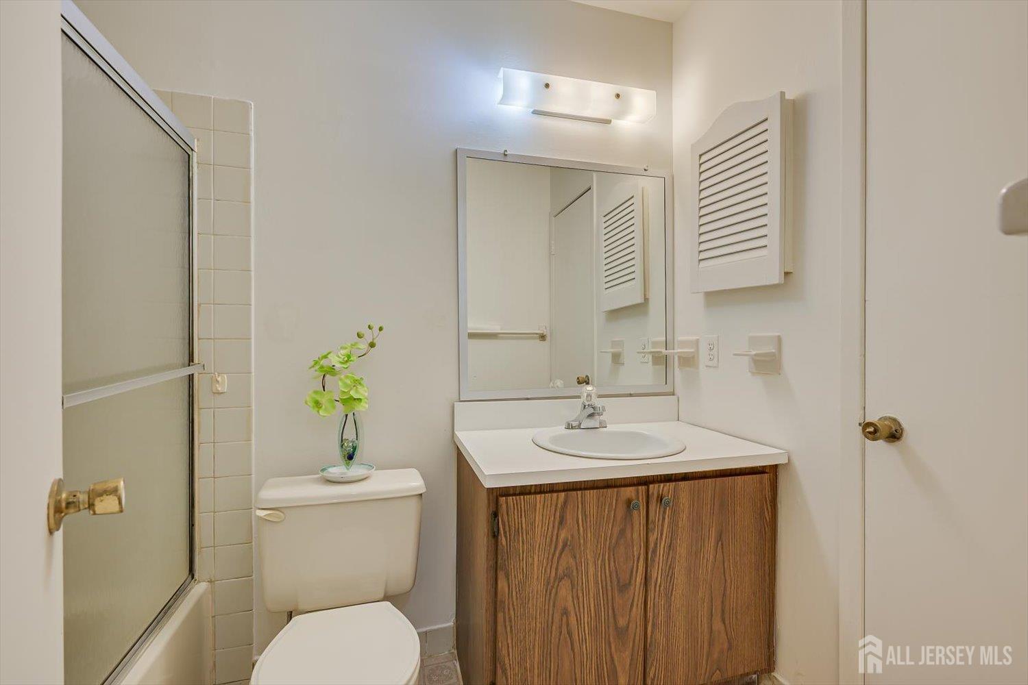112 Redbud Road Piscataway, NJ 08854 - Photo 17 of 27 a bathroom with a granite countertop sink toilet and a mirror