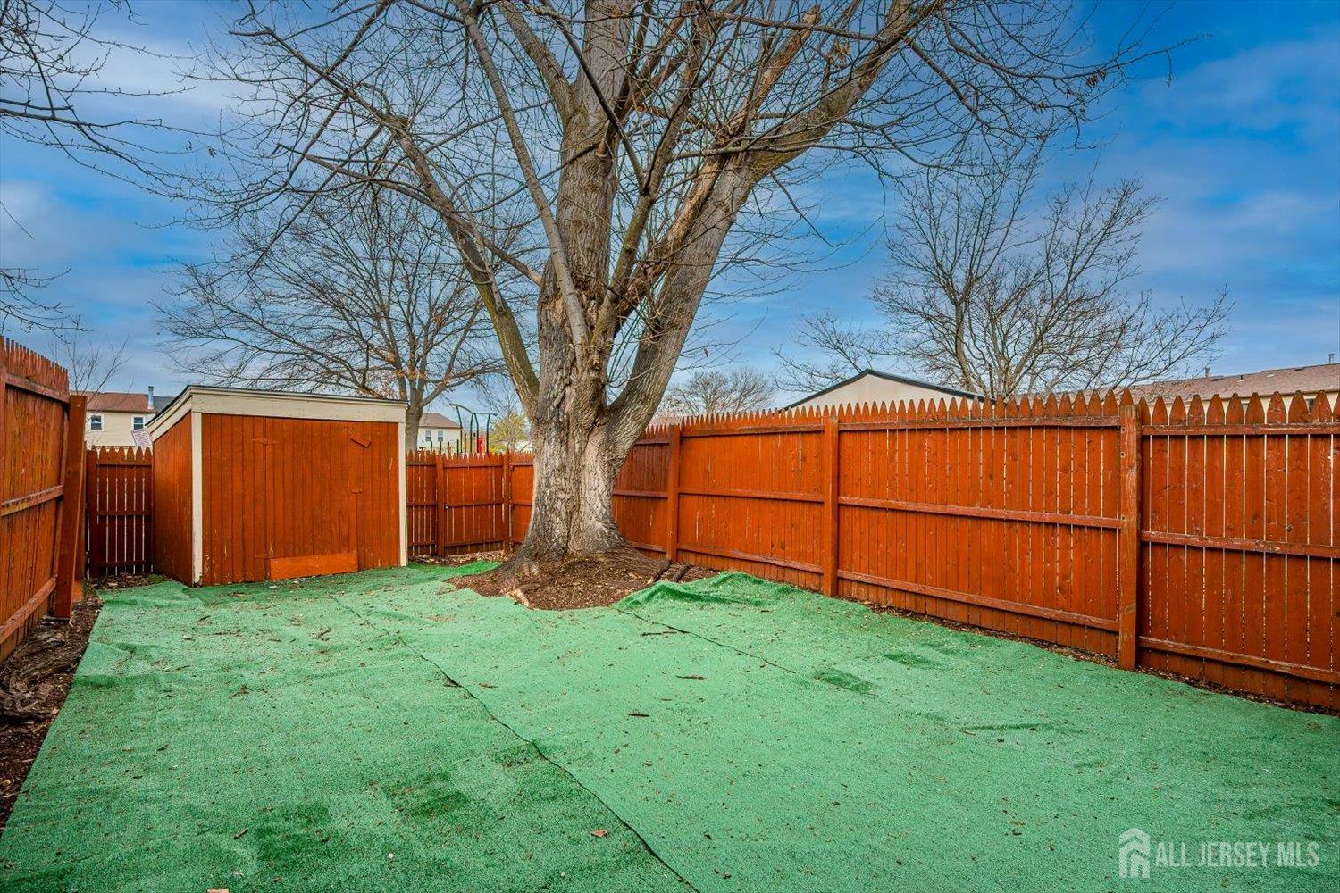 112 Redbud Road Piscataway, NJ 08854 - Photo 22 of 27 a view of a backyard with large trees and a barn