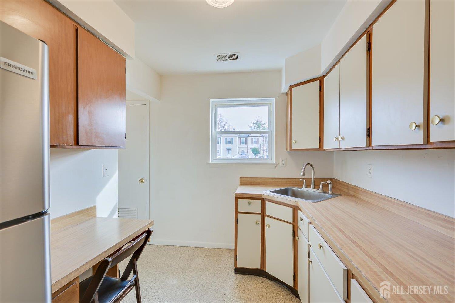 112 Redbud Road Piscataway, NJ 08854 - Photo 9 of 27 a room with a sink cabinets and a window