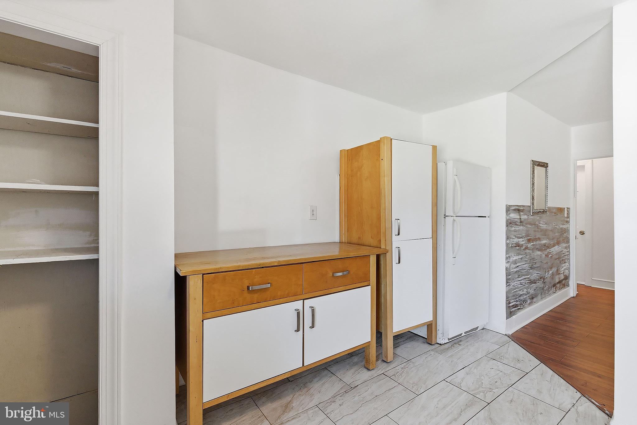 233 Ellis Street Burlington, NJ 08016 - Photo 11 of 36 a view of a kitchen with refrigerator and wooden floor