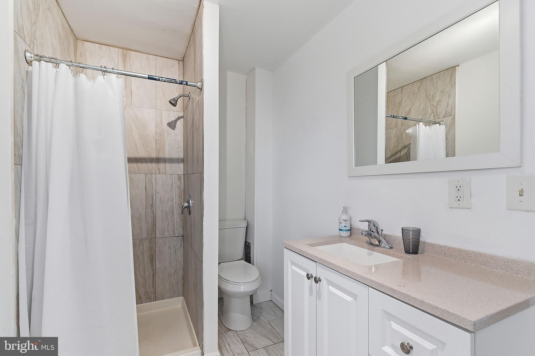 233 Ellis Street Burlington, NJ 08016 - Photo 16 of 36 a bathroom with a granite countertop sink toilet and shower