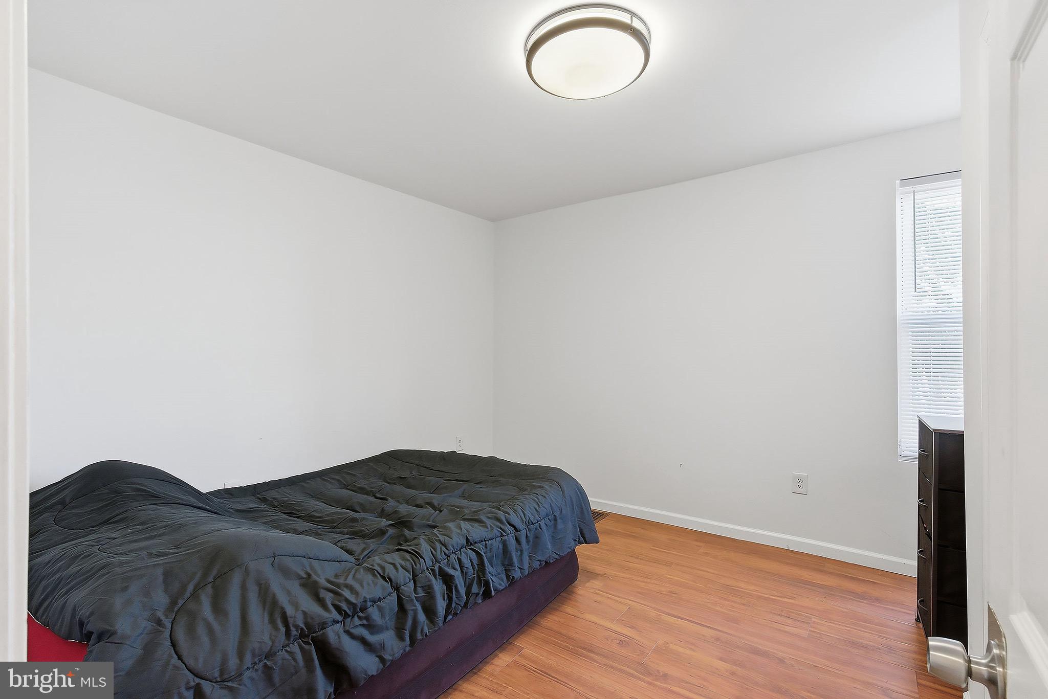 233 Ellis Street Burlington, NJ 08016 - Photo 22 of 36 a bedroom with a bed and wooden floor