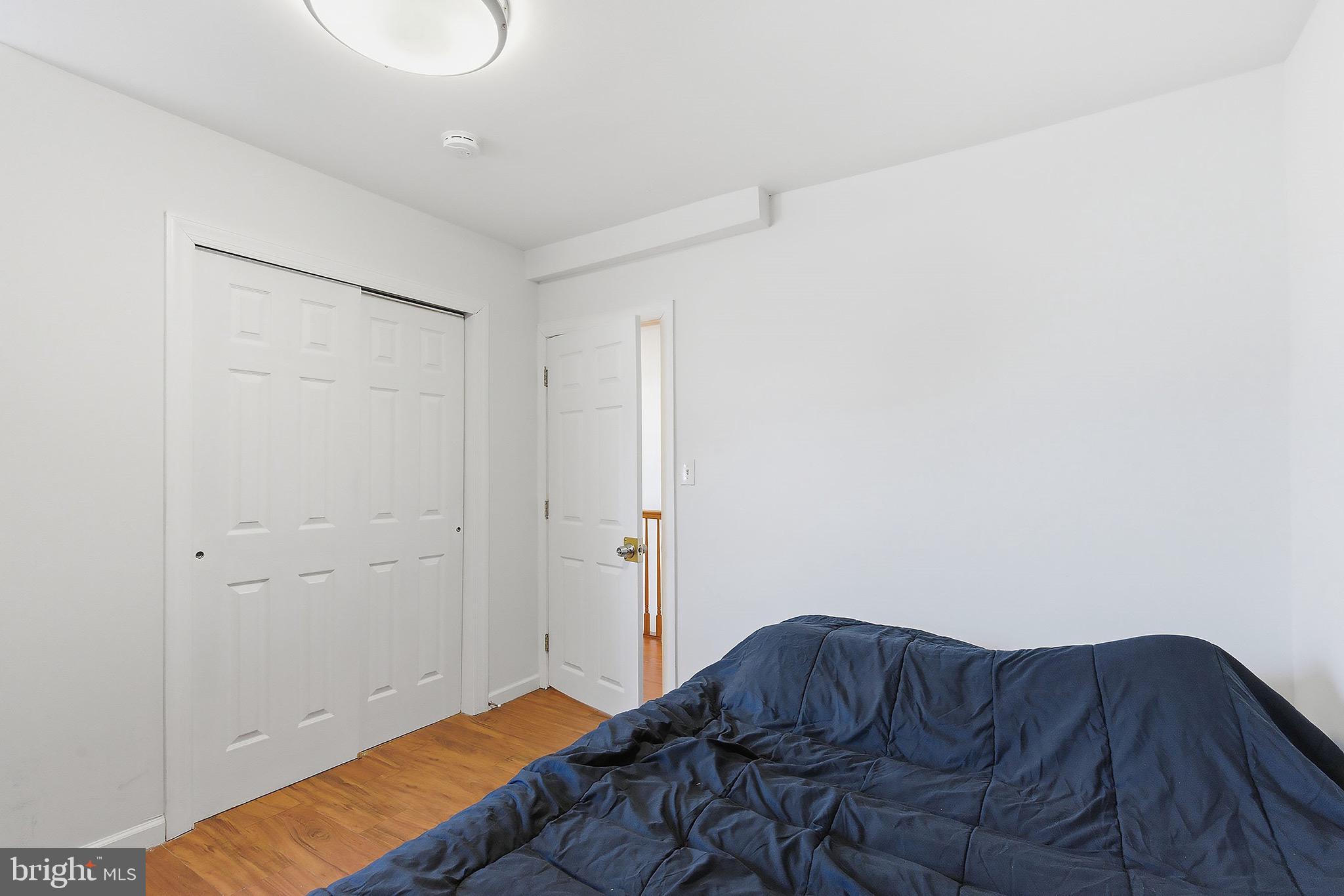 233 Ellis Street Burlington, NJ 08016 - Photo 23 of 36 a bedroom with a bed and a lamp on the dresser