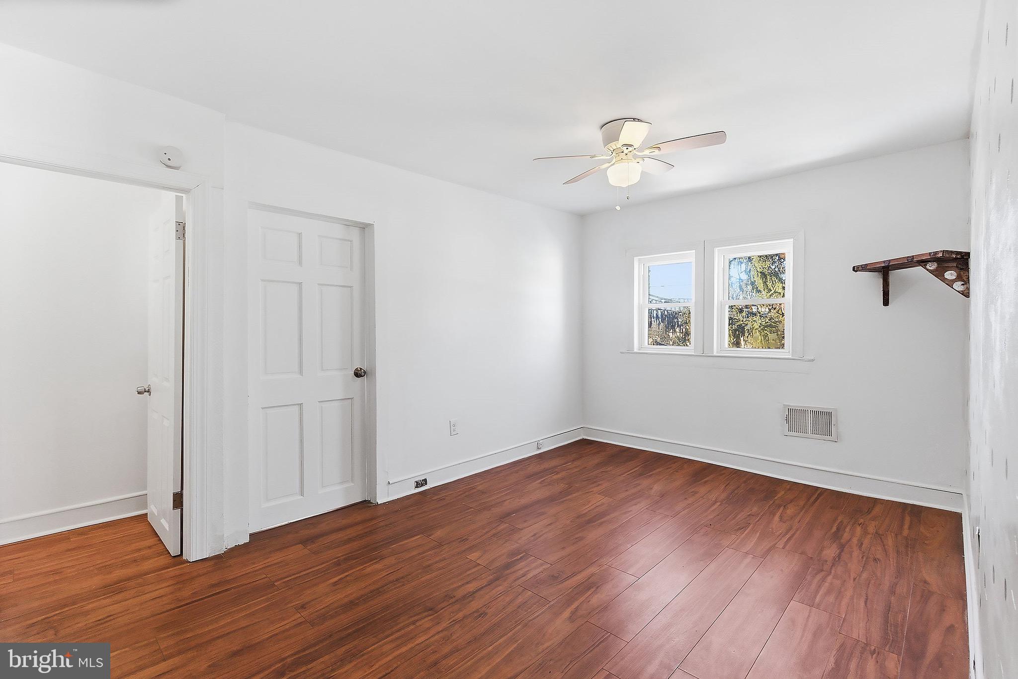 233 Ellis Street Burlington, NJ 08016 - Photo 28 of 36 a view of an empty room with wooden floor and a ceiling fan