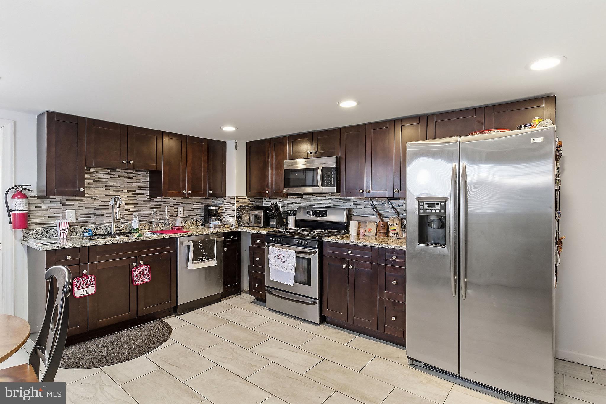 233 Ellis Street Burlington, NJ 08016 - Photo 8 of 36 a kitchen with stainless steel appliances granite countertop a refrigerator and a sink